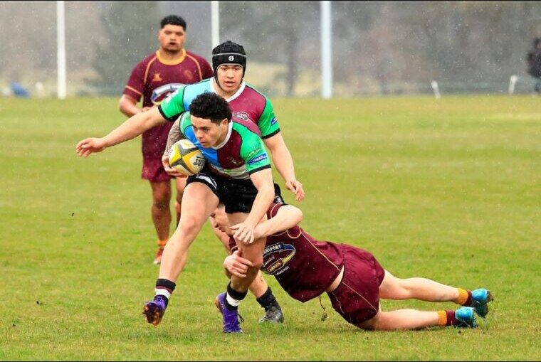 Carson Hunter carrying the ball through contact in touch rugby